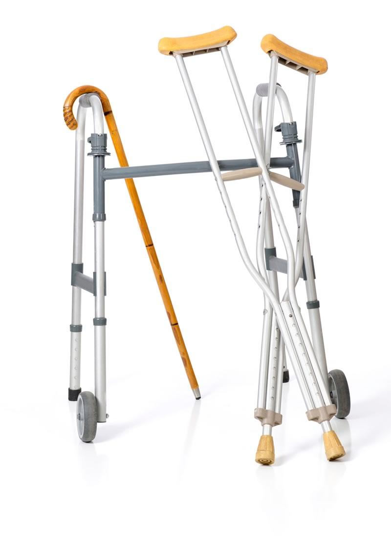 Image of a walker, a pair of crutches, and a wooden cane. 